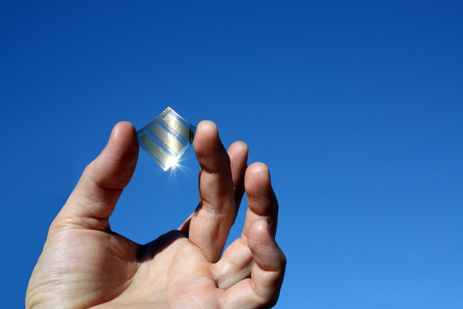 A picture of a hand holding a little mirror.