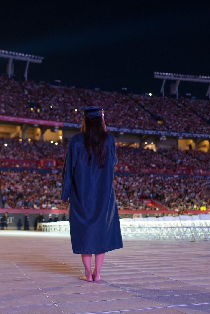 This is an image of a recent University of Arizona graduate recieving her diploma.